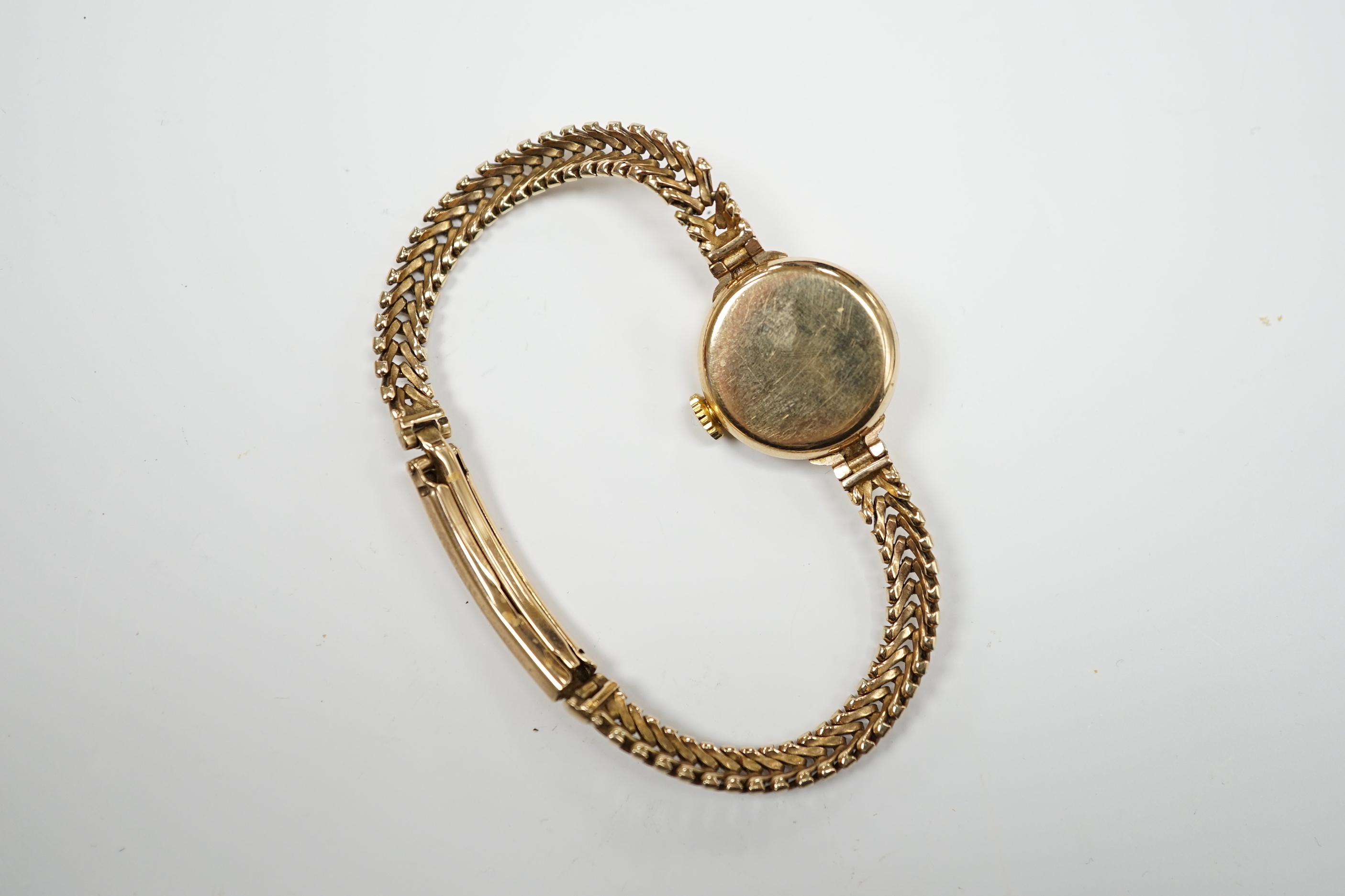 A lady's 9ct gold Omega manual wind wrist watch, on an associated 9ct gold bracelet, gross weight 17.6 grams, with Omega box.